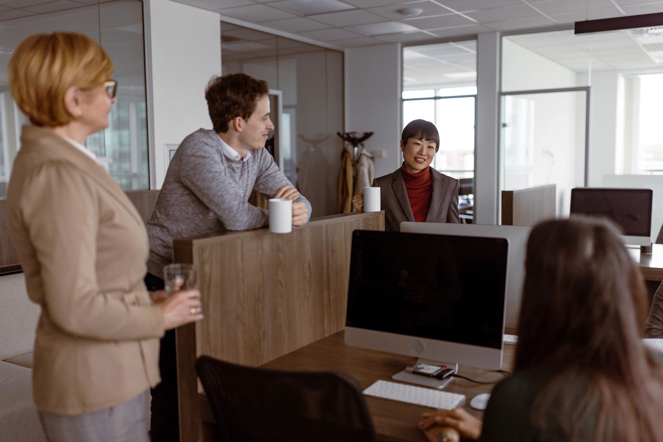 Colleagues discussing hiring decisions in an office