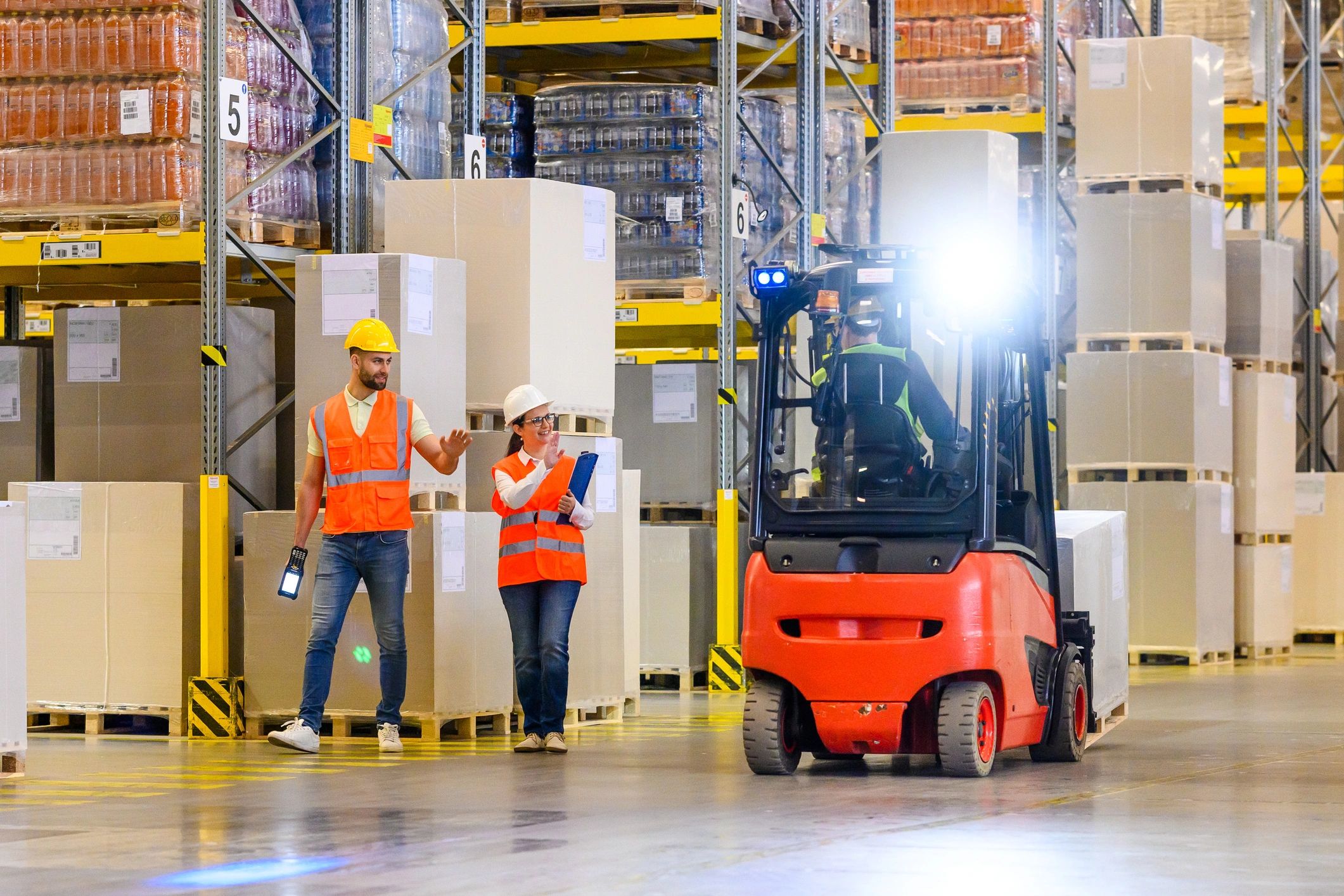 Warehouse workers coordinating inventory operations
